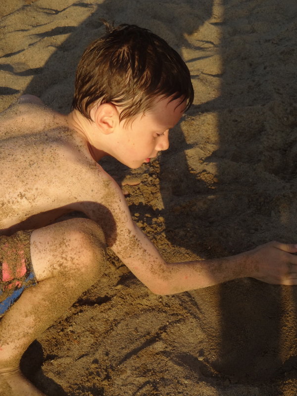 Nate enjoying the warmth of the sand